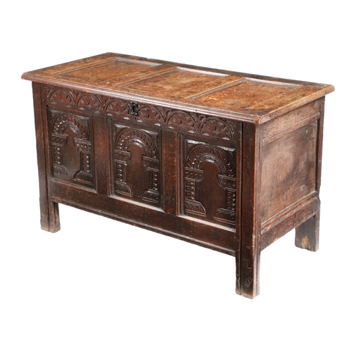 587 - A CHARLES I OAK COFFER, CIRCA 1640. Having a triple-panelled hinged lid and front, each front panel ... 