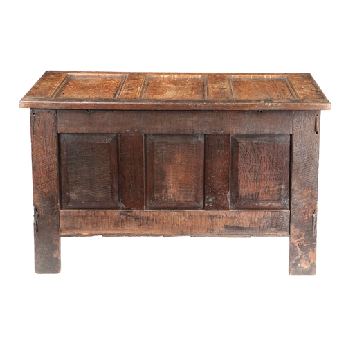 587 - A CHARLES I OAK COFFER, CIRCA 1640. Having a triple-panelled hinged lid and front, each front panel ... 