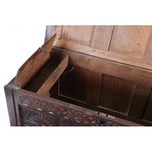 587 - A CHARLES I OAK COFFER, CIRCA 1640. Having a triple-panelled hinged lid and front, each front panel ... 