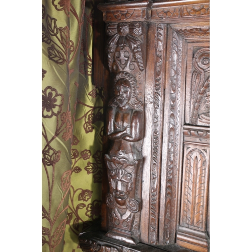 590 - AN IMPRESSIVE ELIZABETH I OAK AND INLAID TESTER BED, CIRCA 1580 AND LATER. The panelled tester centr... 