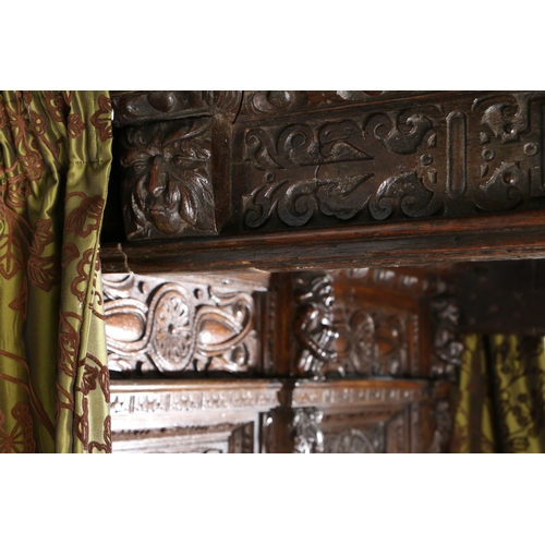 590 - AN IMPRESSIVE ELIZABETH I OAK AND INLAID TESTER BED, CIRCA 1580 AND LATER. The panelled tester centr... 