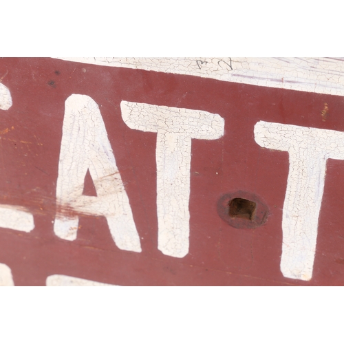 62 - AN AMERICAN FOLK ART SIGN. CATTLE CROSSING, in white lettering and red ground, 64cm wide, 33cm high.