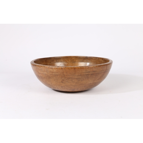 64 - A 19TH CENTURY SYCAMORE TURNED BOWL. Traditional form with high sides and ring marks to the exterior... 