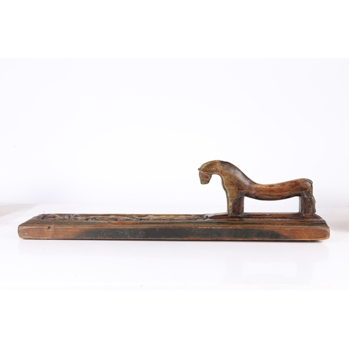 69 - A 19TH CENTURY SCANDINAVIAN TREEN MANGLE BOARD. carved with scrolling leaves and with a stylized hor... 