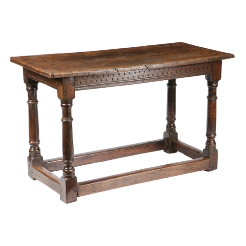 7 - A 17TH CENTURY OAK TABLE. the rectangular top above turned knopped legs united by plain stretchers, ... 