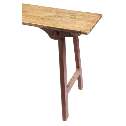 70 - A 19TH CENTURY IRISH FOLDING PINE TABLE. The rectangular top above a red pained underside and foldin... 