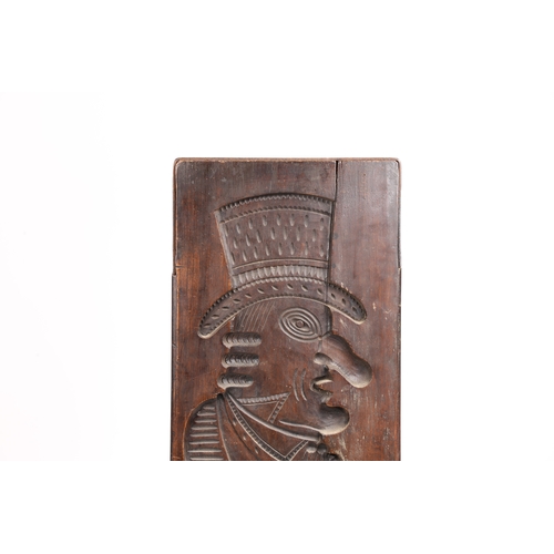 71 - A LARGE GERMAN CARVED FRUITWOOD GINGERBREAD MOULD 19TH CENTURY. Carved in low relief depicting a man... 