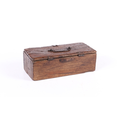 73 - AN UNUSUAL DUG-OUT BOX, POSSIBLY ELM. Having a hinged lid with iron bale handle, the base formed fro... 