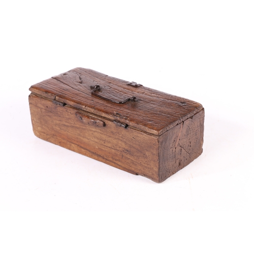 73 - AN UNUSUAL DUG-OUT BOX, POSSIBLY ELM. Having a hinged lid with iron bale handle, the base formed fro... 