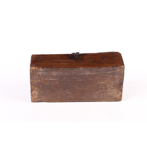 73 - AN UNUSUAL DUG-OUT BOX, POSSIBLY ELM. Having a hinged lid with iron bale handle, the base formed fro... 