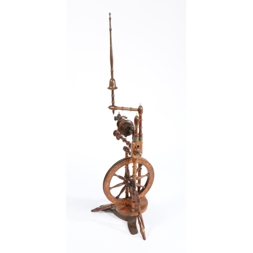 78 - A GEORGE III YEW WOOD SPINNING WHEEL. With turned uprights and wheel held above the shaped base and ... 