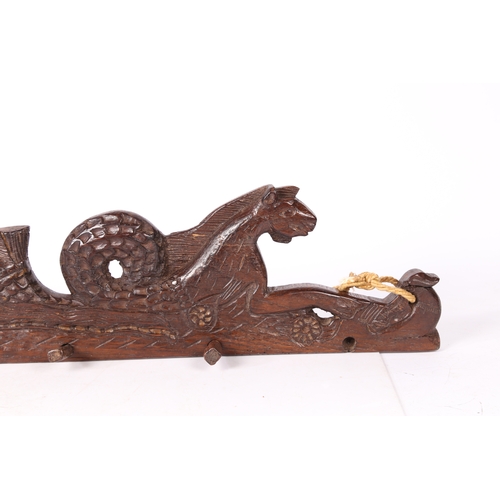 79 - A 17TH CENTURY CARVED OAK RAIL, CIRCA 1660. Designed as a hippocamp, of elongated form, with a bird ... 