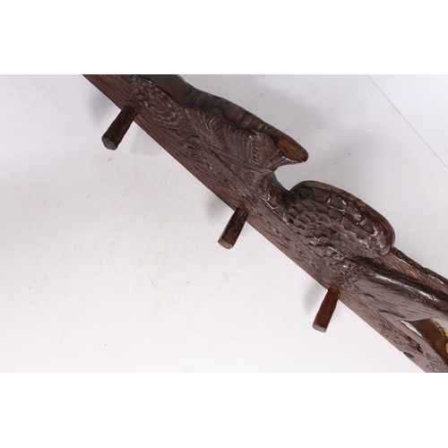 79 - A 17TH CENTURY CARVED OAK RAIL, CIRCA 1660. Designed as a hippocamp, of elongated form, with a bird ... 