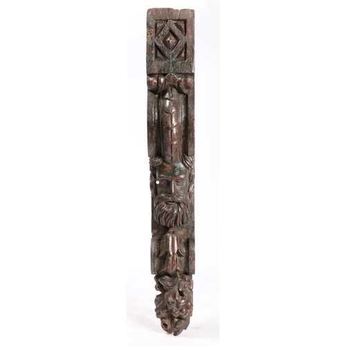 82 - A LARGE LATE 17TH CENTURY PINE AND POLYCHROME CORBEL. Carved with a male head, with full facial hair... 