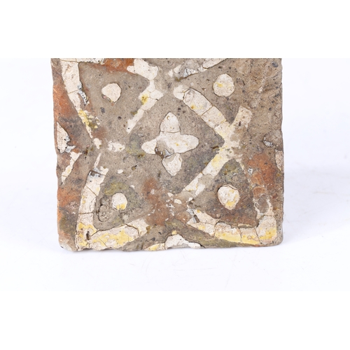 89 - A 15TH CENTURY EARTHENWARE FLOOR TILE, ENGLISH. Decorated with a creamy-while slip quatrefoil design... 