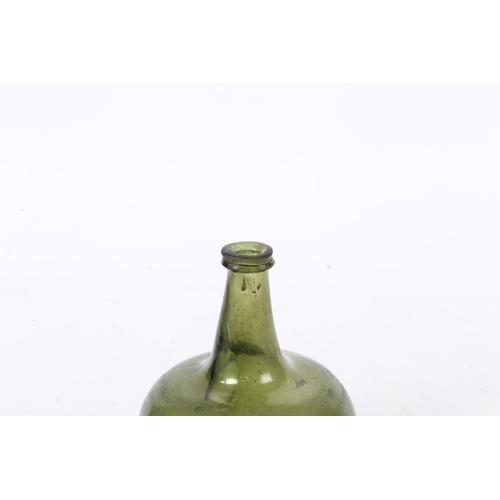 93 - A 18TH CENTURY ENGLISH ONION WINE BOTTLE. having a dumpy stem and a bulbous body, 17cm high.