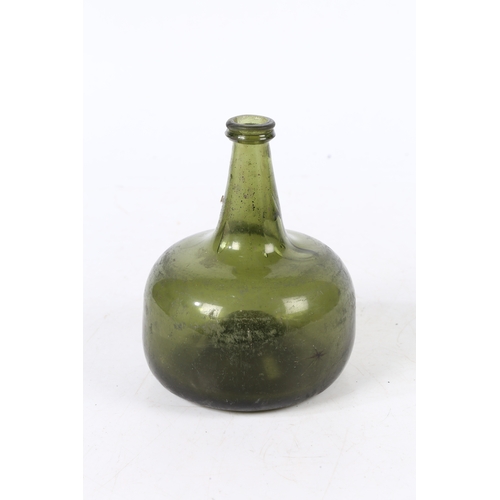 93 - A 18TH CENTURY ENGLISH ONION WINE BOTTLE. having a dumpy stem and a bulbous body, 17cm high.