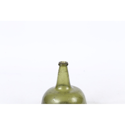 94 - A 18TH CENTURY ENGLISH ONION WINE BOTTLE. having a dumpy stem and bulbous body, 16.5cm high.