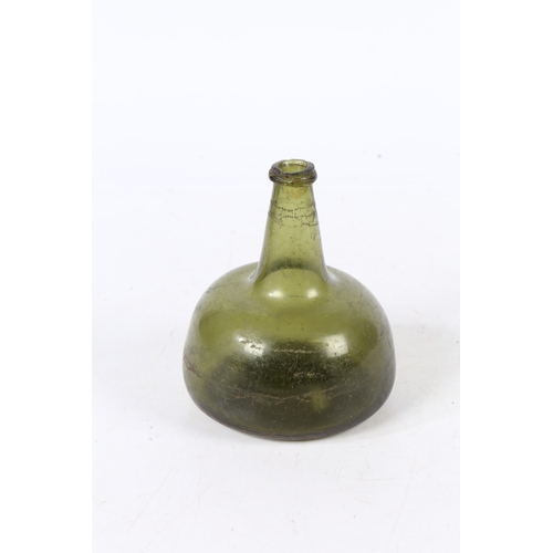 94 - A 18TH CENTURY ENGLISH ONION WINE BOTTLE. having a dumpy stem and bulbous body, 16.5cm high.