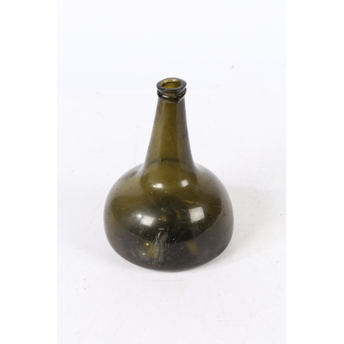 95 - A 18TH CENTURY ENGLISH ONION WINE BOTTLE. having a dumpy stem above a bulbous body, 18.5cm high.