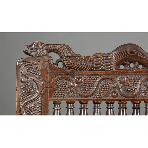 105 - AN EXCEPTIONAL LARGE ELIZABETHAN OAK SETTLE, WITH REMARAKBLE DOUBLE SERPENT CRESTING IN WALNUT, ENGL... 