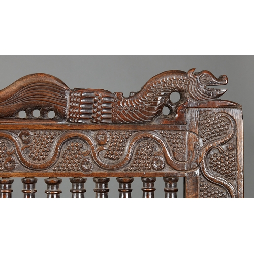 105 - AN EXCEPTIONAL LARGE ELIZABETHAN OAK SETTLE, WITH REMARAKBLE DOUBLE SERPENT CRESTING IN WALNUT, ENGL... 