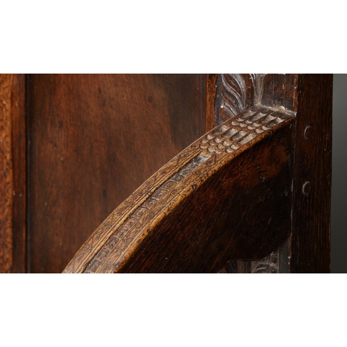 105 - AN EXCEPTIONAL LARGE ELIZABETHAN OAK SETTLE, WITH REMARAKBLE DOUBLE SERPENT CRESTING IN WALNUT, ENGL... 