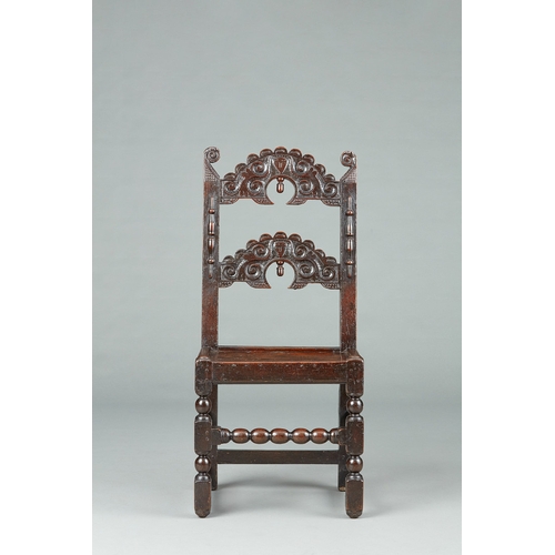 107 - A FINE QUALITY OAK SINGLE CHAIR WITH TWIN MASKS, YORKSHIRE, CIRCA 1650-1660. The splayed uprights te... 