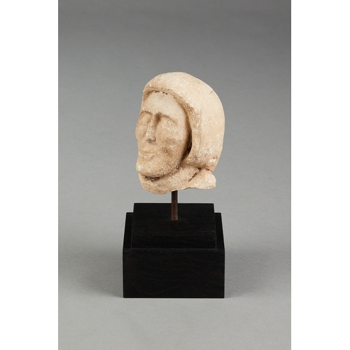 108 - A SMALL 15TH CENTURY PORTLAND STONE HEAD OF A MONK, ENGLISH, DORSET, CIRCA 14001450. The small size... 