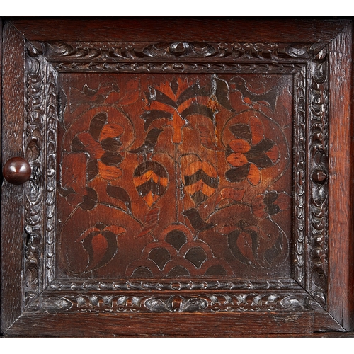 19 - A CHARLES I INLAID OAK CANTED CUPBOARD, YORKSHIRE, LEEDS/HALIFAX, CIRCA 1630. The plank top above ra... 