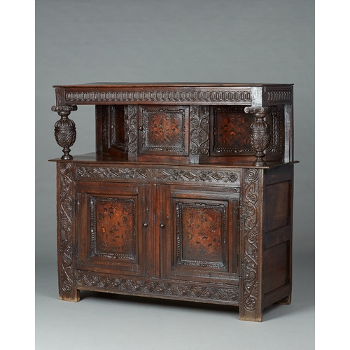 19 - A CHARLES I INLAID OAK CANTED CUPBOARD, YORKSHIRE, LEEDS/HALIFAX, CIRCA 1630. The plank top above ra... 