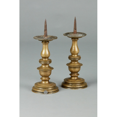 24 - A FINE AND BOLD PAIR OF LARGE 16TH CENTURY BRASS CANDLESTICKS, GERMAN, CIRCA 1580. The large pair of... 