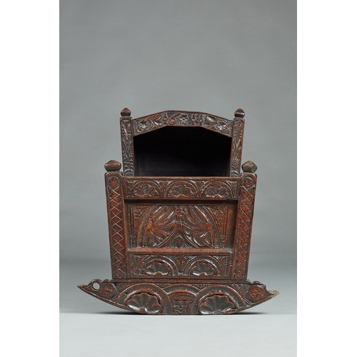 27 - A RARE AND HIGHLY UNUSUAL JAMES I OAK CRADLE, CUMBRIA, DATED 1611. The hooded cradle surmounted by f... 