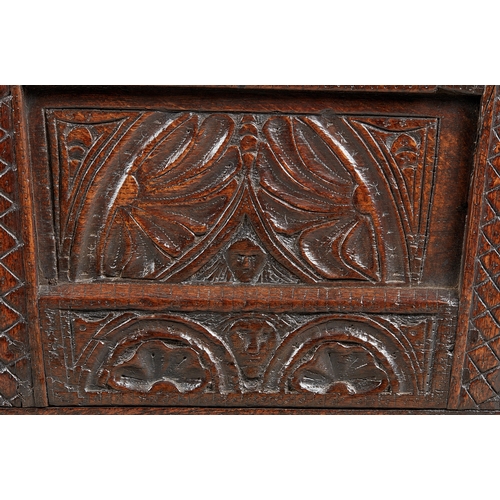 27 - A RARE AND HIGHLY UNUSUAL JAMES I OAK CRADLE, CUMBRIA, DATED 1611. The hooded cradle surmounted by f... 