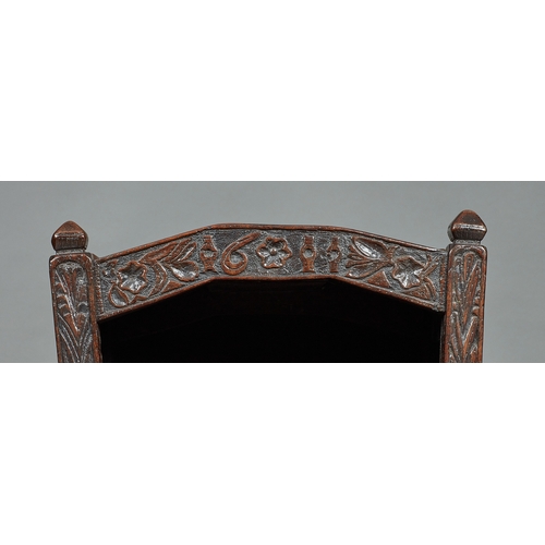 27 - A RARE AND HIGHLY UNUSUAL JAMES I OAK CRADLE, CUMBRIA, DATED 1611. The hooded cradle surmounted by f... 