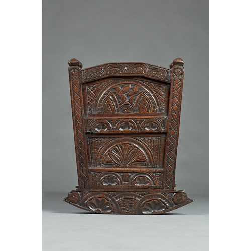 27 - A RARE AND HIGHLY UNUSUAL JAMES I OAK CRADLE, CUMBRIA, DATED 1611. The hooded cradle surmounted by f... 