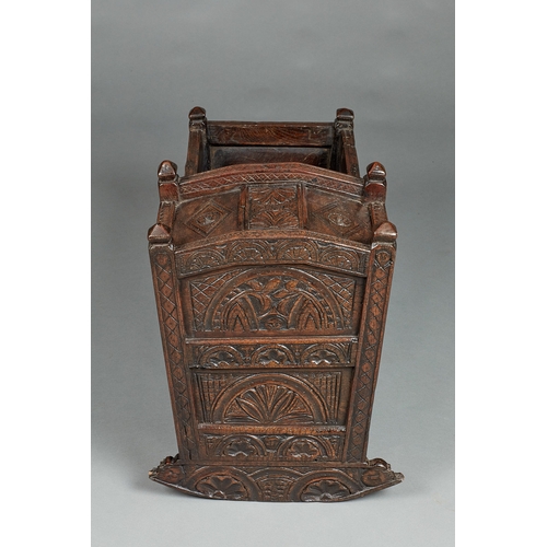 27 - A RARE AND HIGHLY UNUSUAL JAMES I OAK CRADLE, CUMBRIA, DATED 1611. The hooded cradle surmounted by f... 