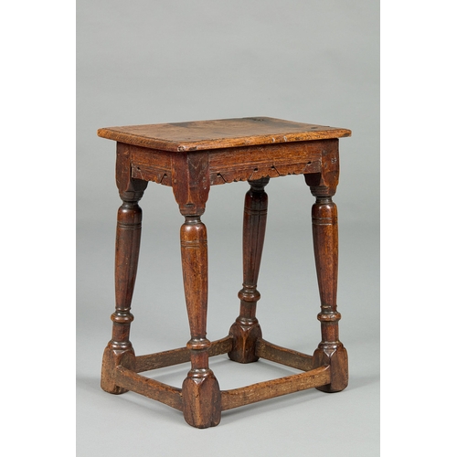 28 - A FINE ELIZABETH I CARVED OAK JOINT STOOL, ENGLISH CIRCA 1590-1600. The moulded plank top above shap... 