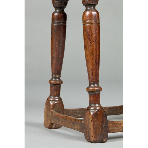 28 - A FINE ELIZABETH I CARVED OAK JOINT STOOL, ENGLISH CIRCA 1590-1600. The moulded plank top above shap... 