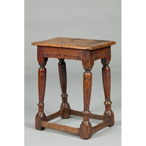 28 - A FINE ELIZABETH I CARVED OAK JOINT STOOL, ENGLISH CIRCA 1590-1600. The moulded plank top above shap... 