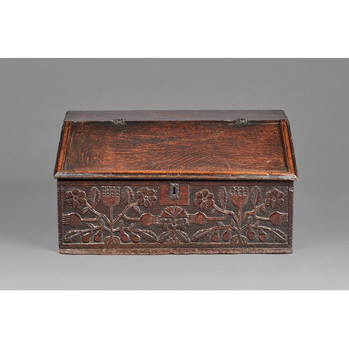 3 - A FINE CHARLES II OAK DESK /WRITING BOX, CARVED WITH THISTLES LANCASHIRE, CIRCA 1660-1670. The high-... 