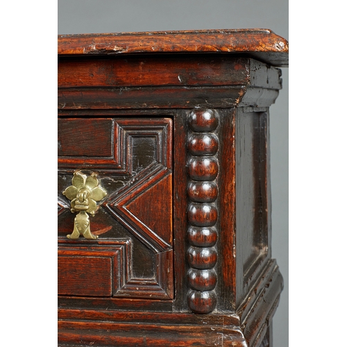 42 - A SMALL CHARLES II OAK AND ELM DRESSER BASE, CIRCA 1670-1680. The twin Elm plank top of exceptional ... 