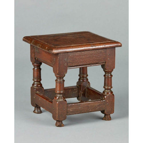 48 - A FINE CHARLES I OAK LOW OR CHILDS JOINED STOOL, ENGLISH, CIRCA 1630-1640. The bold moulded top with... 