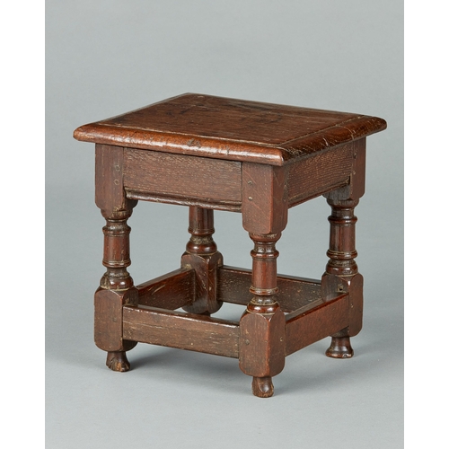 48 - A FINE CHARLES I OAK LOW OR CHILDS JOINED STOOL, ENGLISH, CIRCA 1630-1640. The bold moulded top with... 