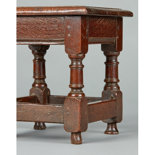 48 - A FINE CHARLES I OAK LOW OR CHILDS JOINED STOOL, ENGLISH, CIRCA 1630-1640. The bold moulded top with... 