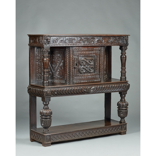 60 - AN ELIZABETH I OAK CANTED LIVERY CUPBOARD, GLOUCESTERSHIRE, CIRCA 15901600. The canted upper sectio... 