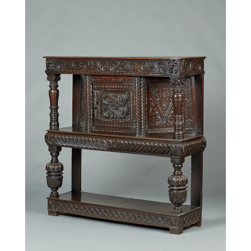 60 - AN ELIZABETH I OAK CANTED LIVERY CUPBOARD, GLOUCESTERSHIRE, CIRCA 15901600. The canted upper sectio... 