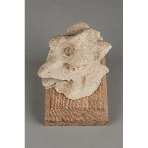 61 - A RARE MEDIEVAL 15TH CENTURY OOLITIC FOSSIL LIMESTONE GRIFFIN HEAD, ENGLISH, CIRCA 1400-1450. The sc... 