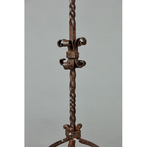 71 - AN ELIZABETHAN WROUGHT IRON CANDELABRA, ENGLISH, CIRCA 1580-1600. Having a single pricket above four... 