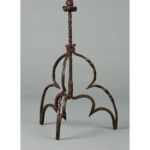 71 - AN ELIZABETHAN WROUGHT IRON CANDELABRA, ENGLISH, CIRCA 1580-1600. Having a single pricket above four... 